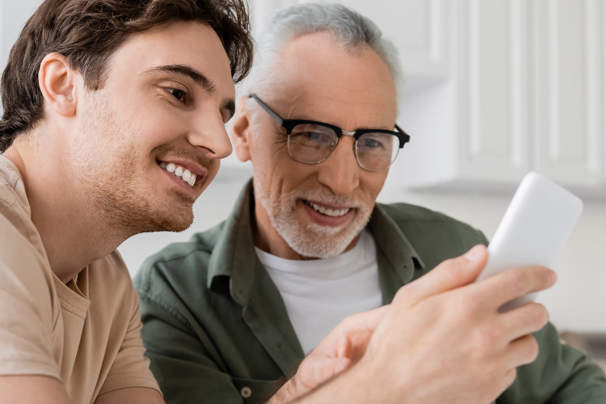 Son & Dad with Phone - FreedomPop_555425521-2 Son & Dad with Phone - FreedomPop_555425521-2